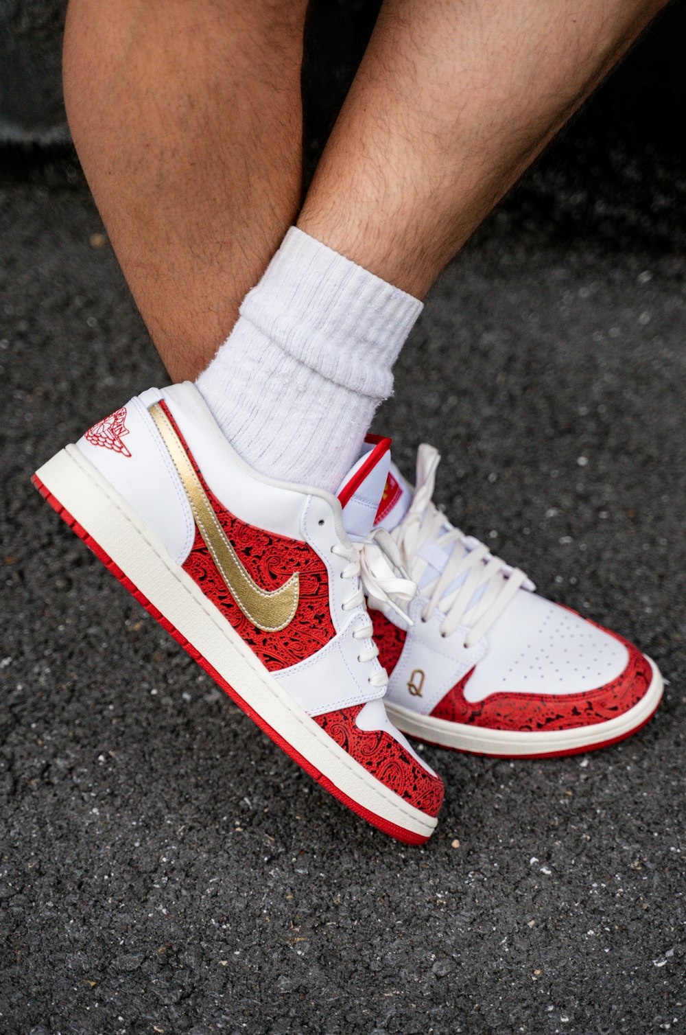 person wearing red and white nike sneakers