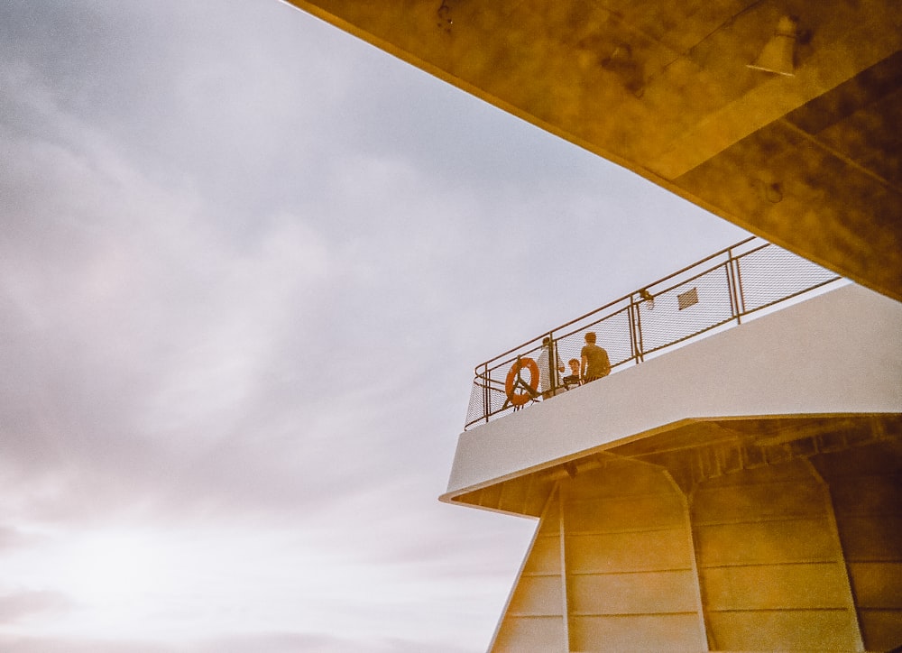 white and brown concrete building under white clouds during daytime