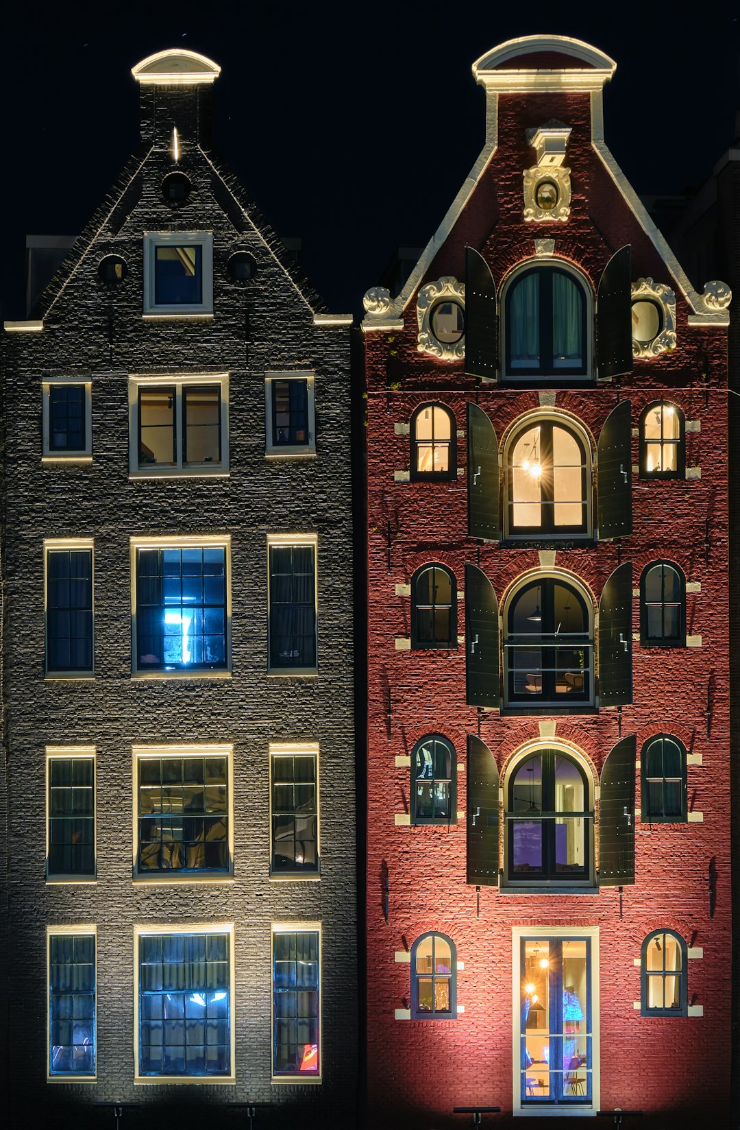 red brick building with lights turned on during night time