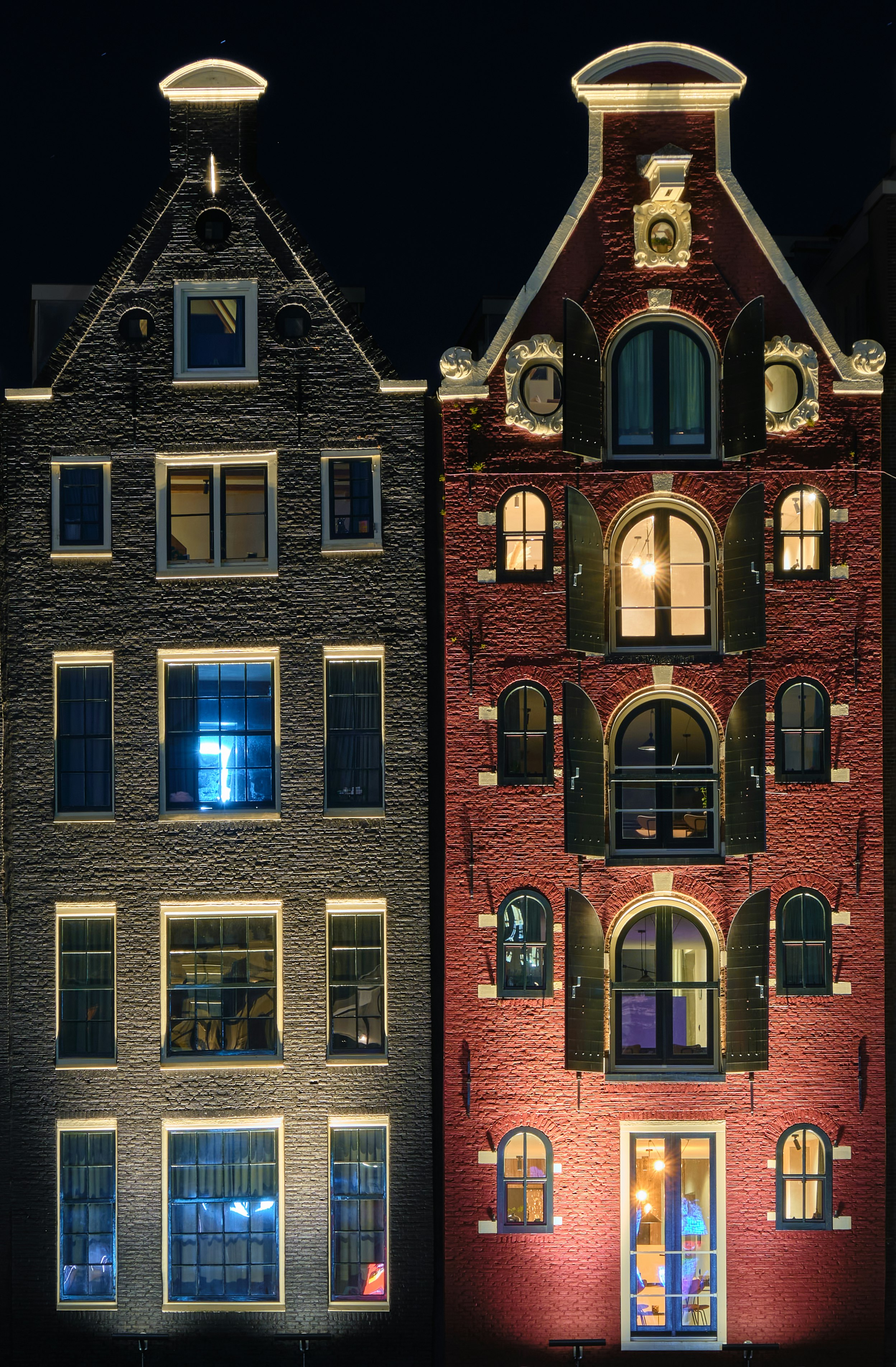 red brick building with lights turned on during night time
