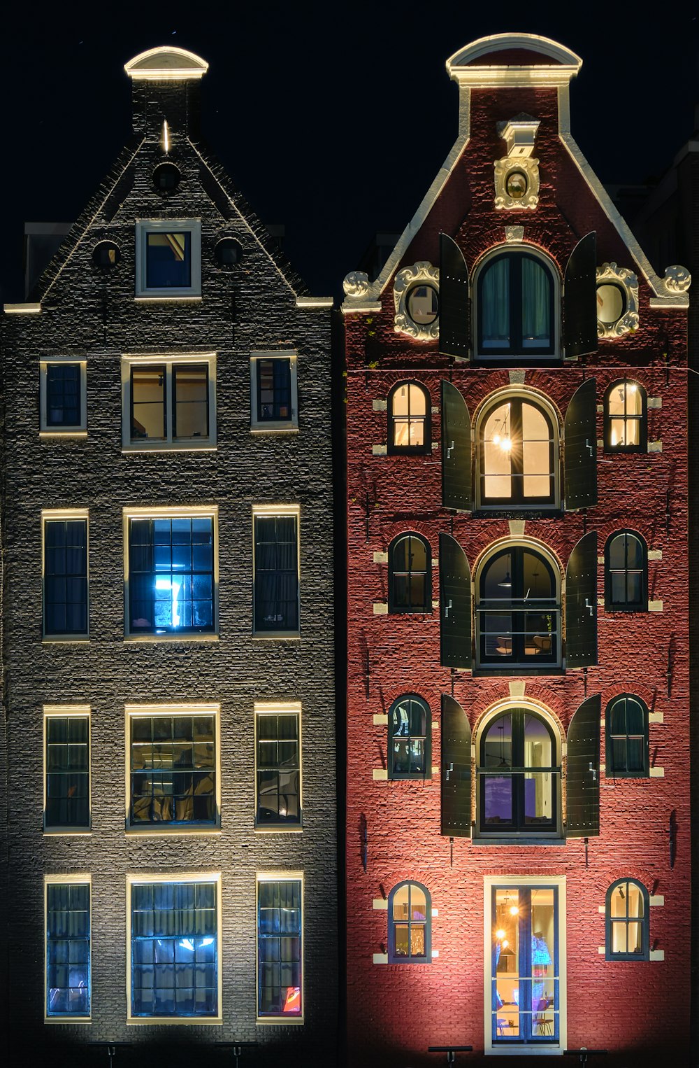 red brick building with lights turned on during night time