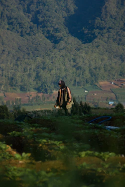 Portrait of Alfredo Garcia standing in a lush green field under a clear sky.