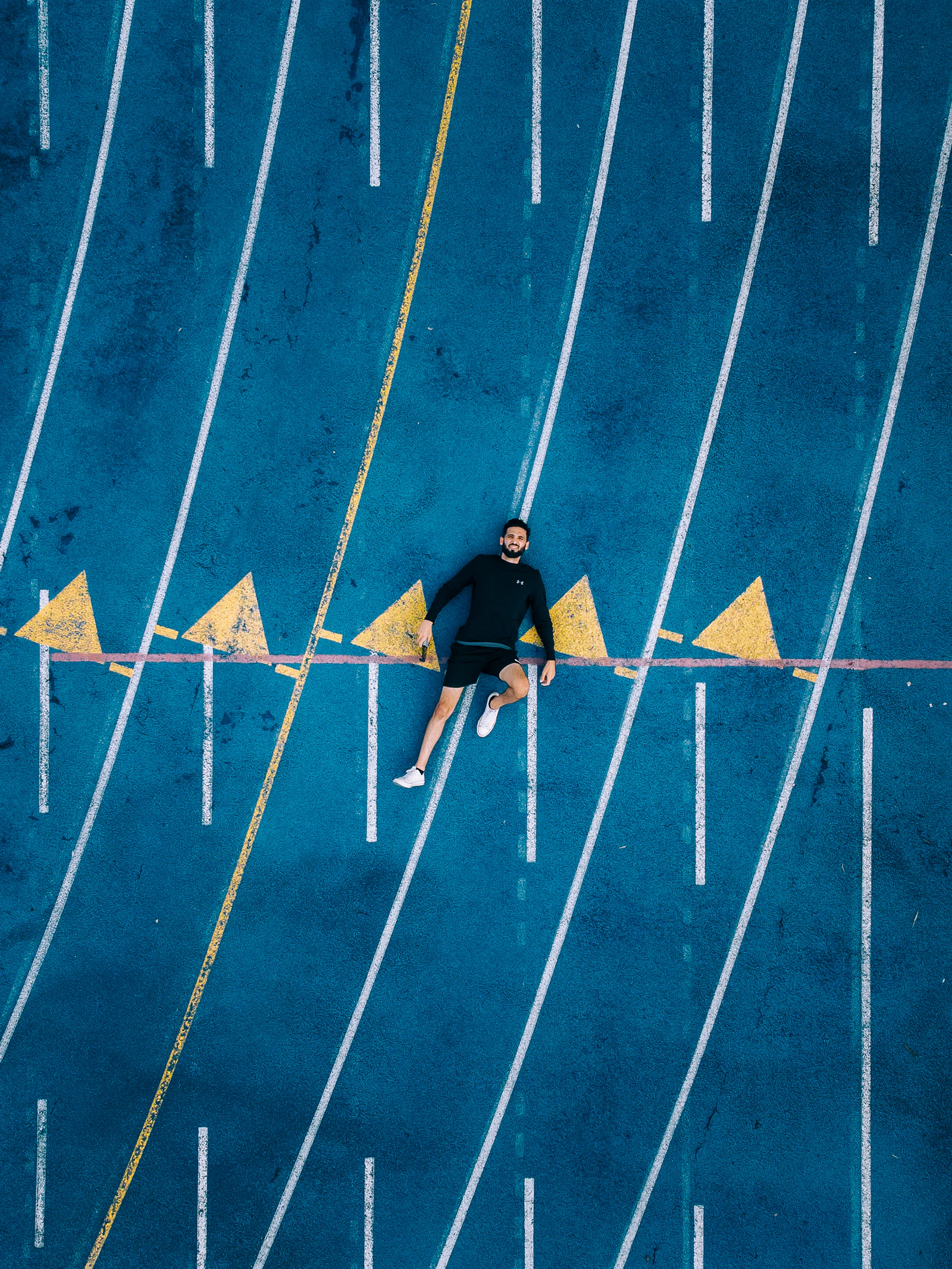 Runners crouched at the starting line of a track, waiting for the gun
