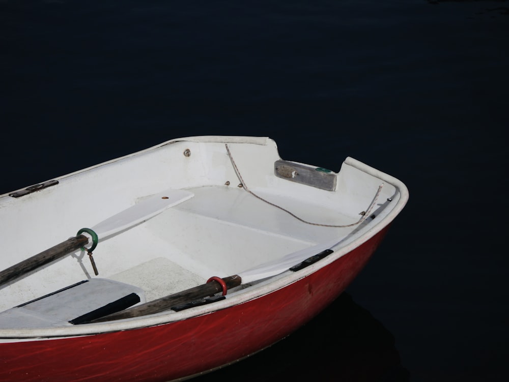 white and red boat on water