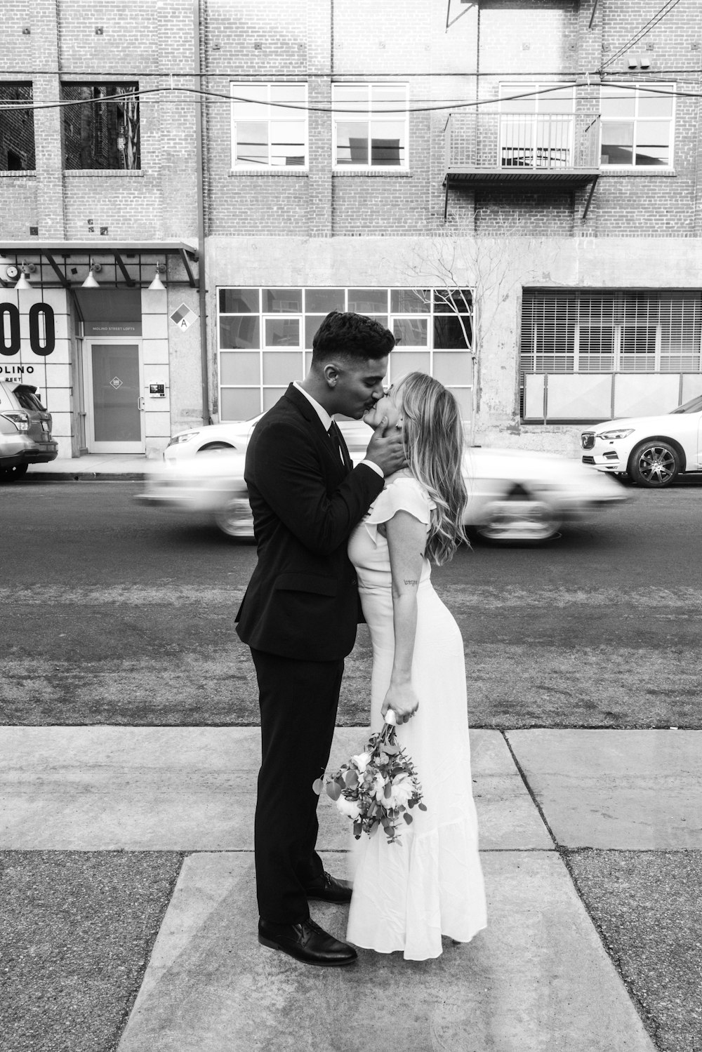 man and woman kissing on street