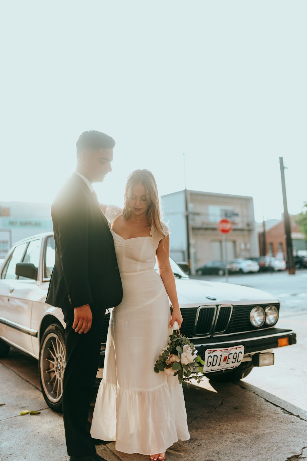 man in black suit standing beside woman in white wedding dress