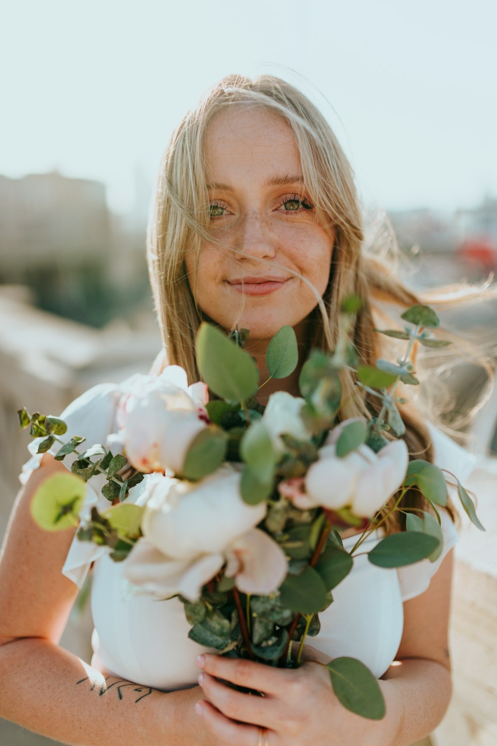 woman holding white flowers during daytime