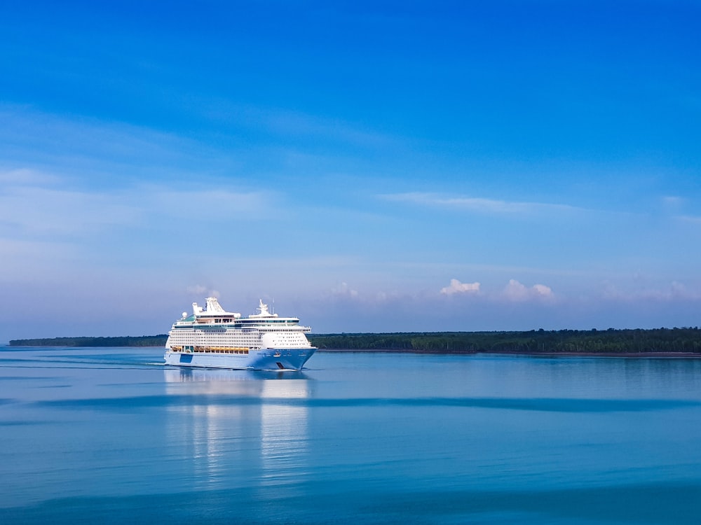white cruise ship on sea under blue sky during daytime