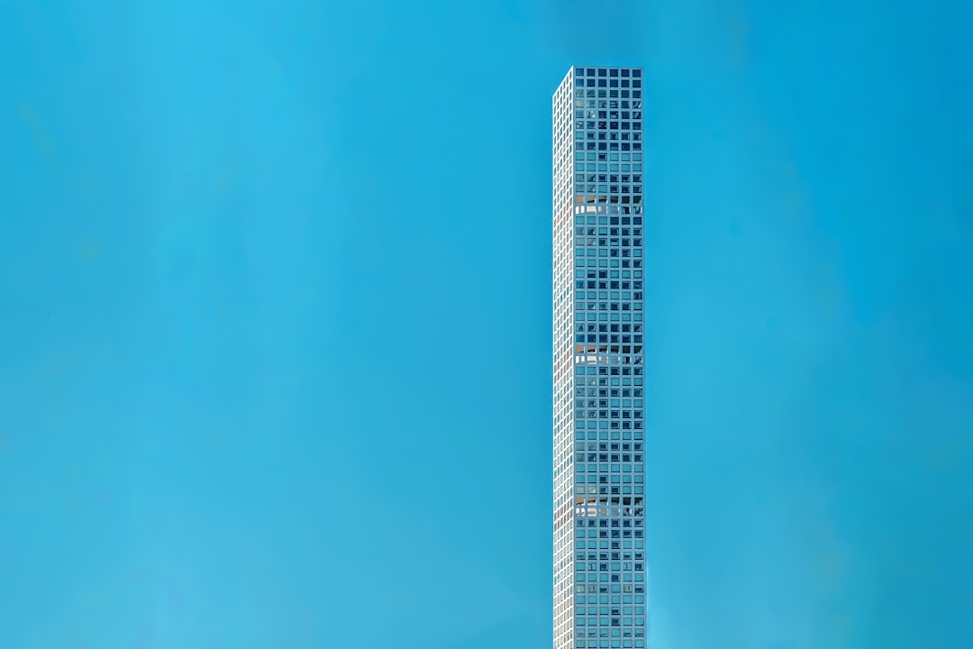 blue and white high rise building under blue sky during daytime