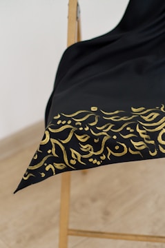 An artistic arrangement of luxurious fabrics in black and gold.