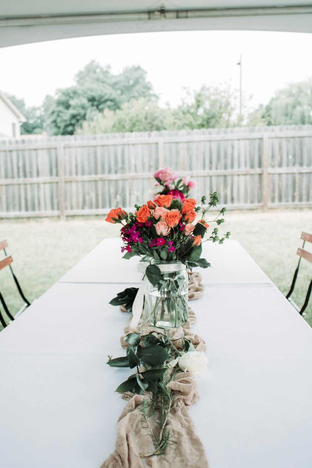 red roses in clear glass vase on white table