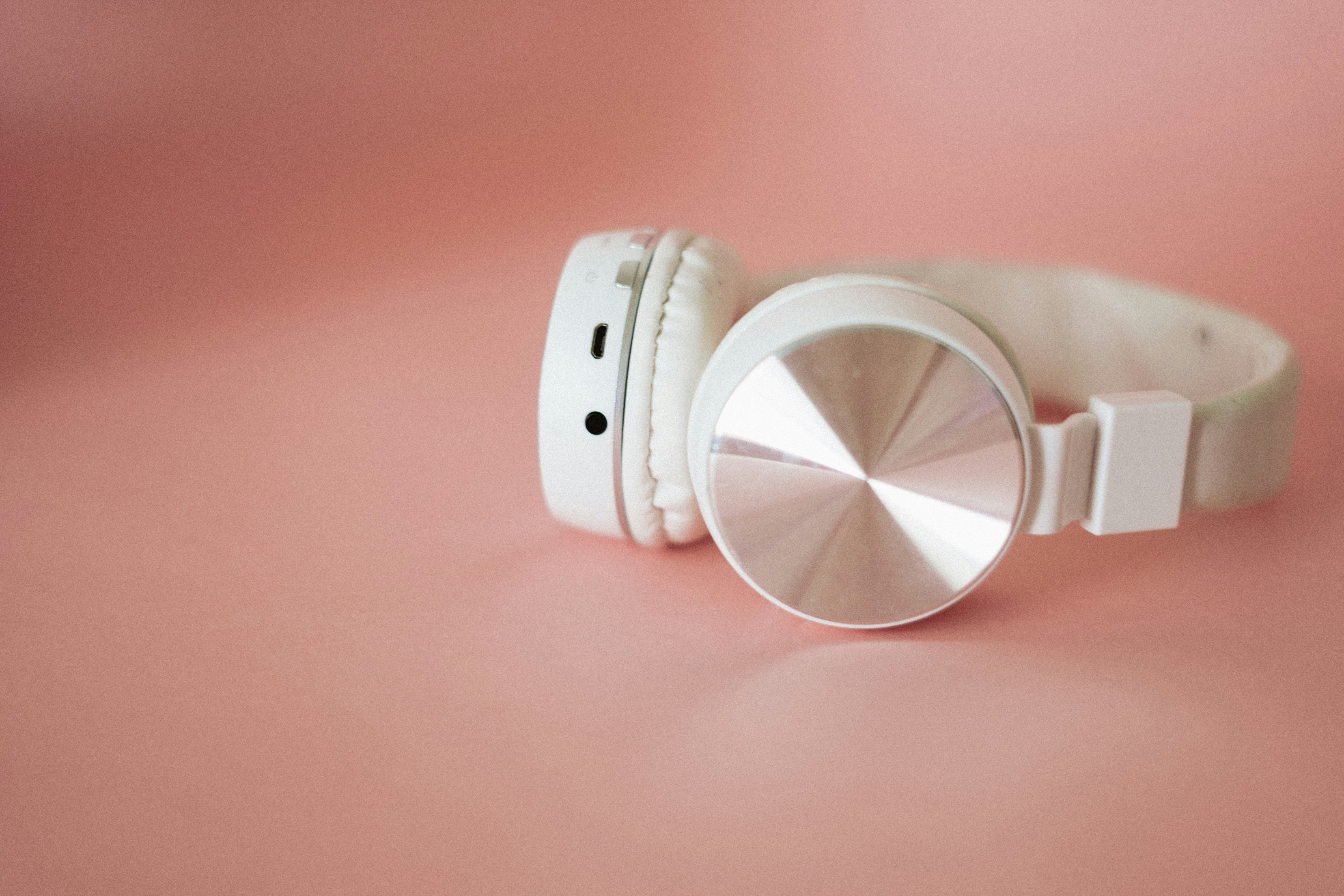 white leather bracelet on pink surface