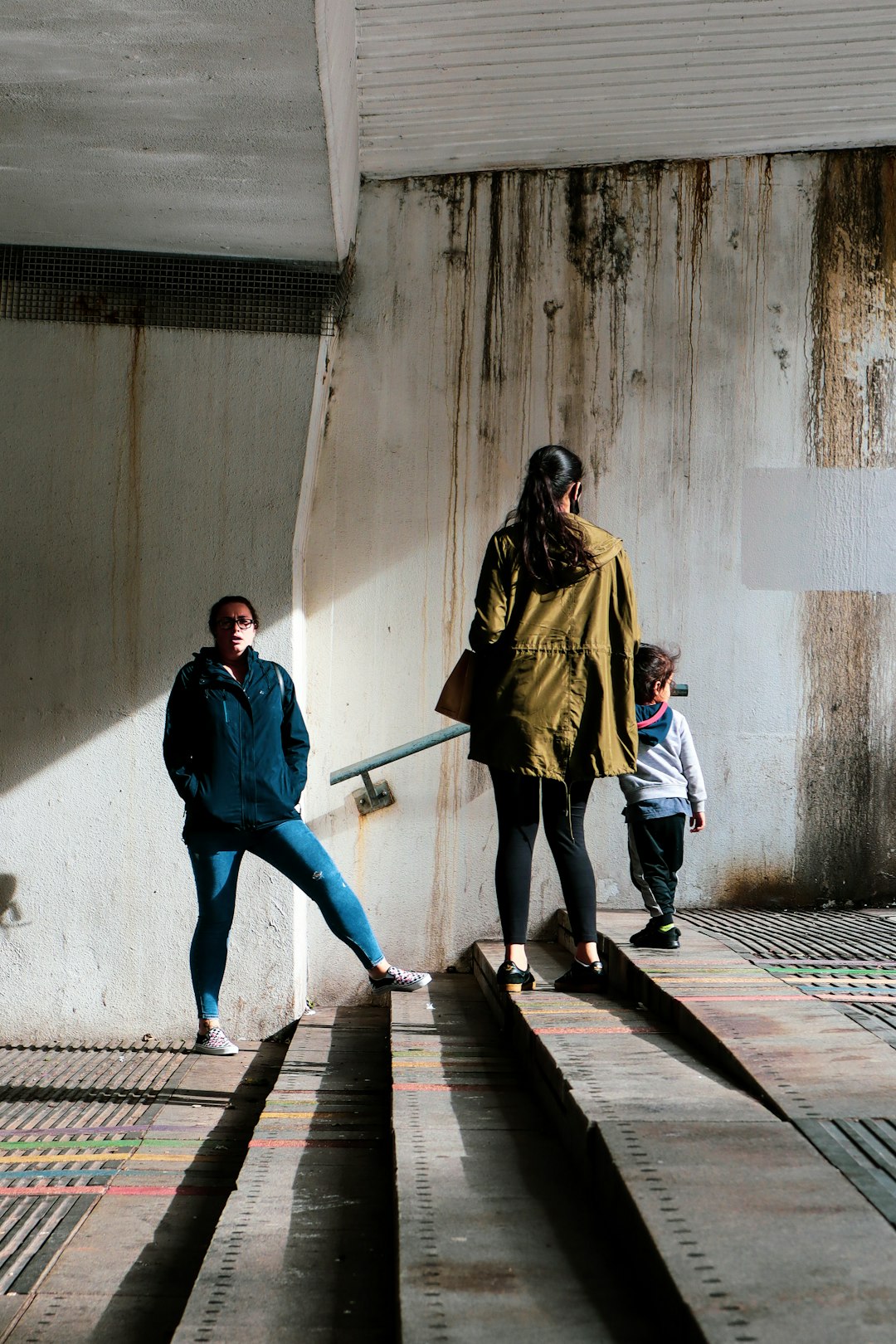 man and woman walking on sidewalk during daytime