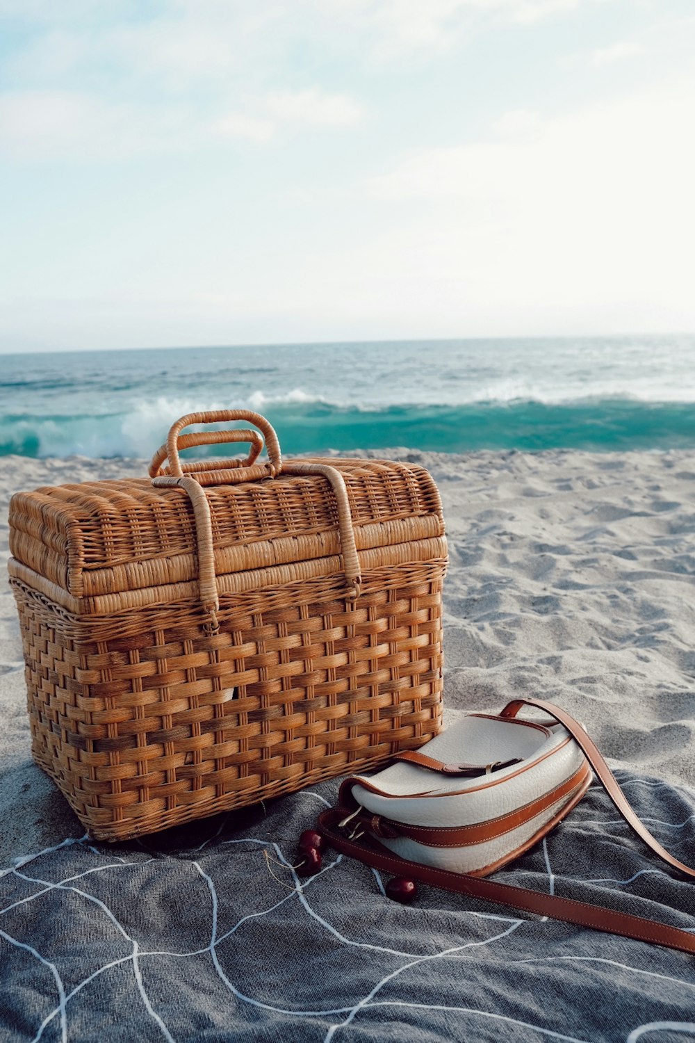brown woven basket on gray sand during daytime