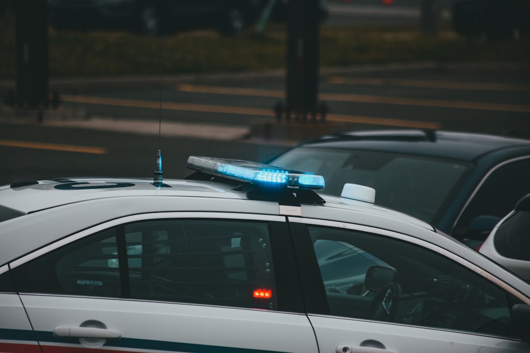 white and black sedan on road during night time