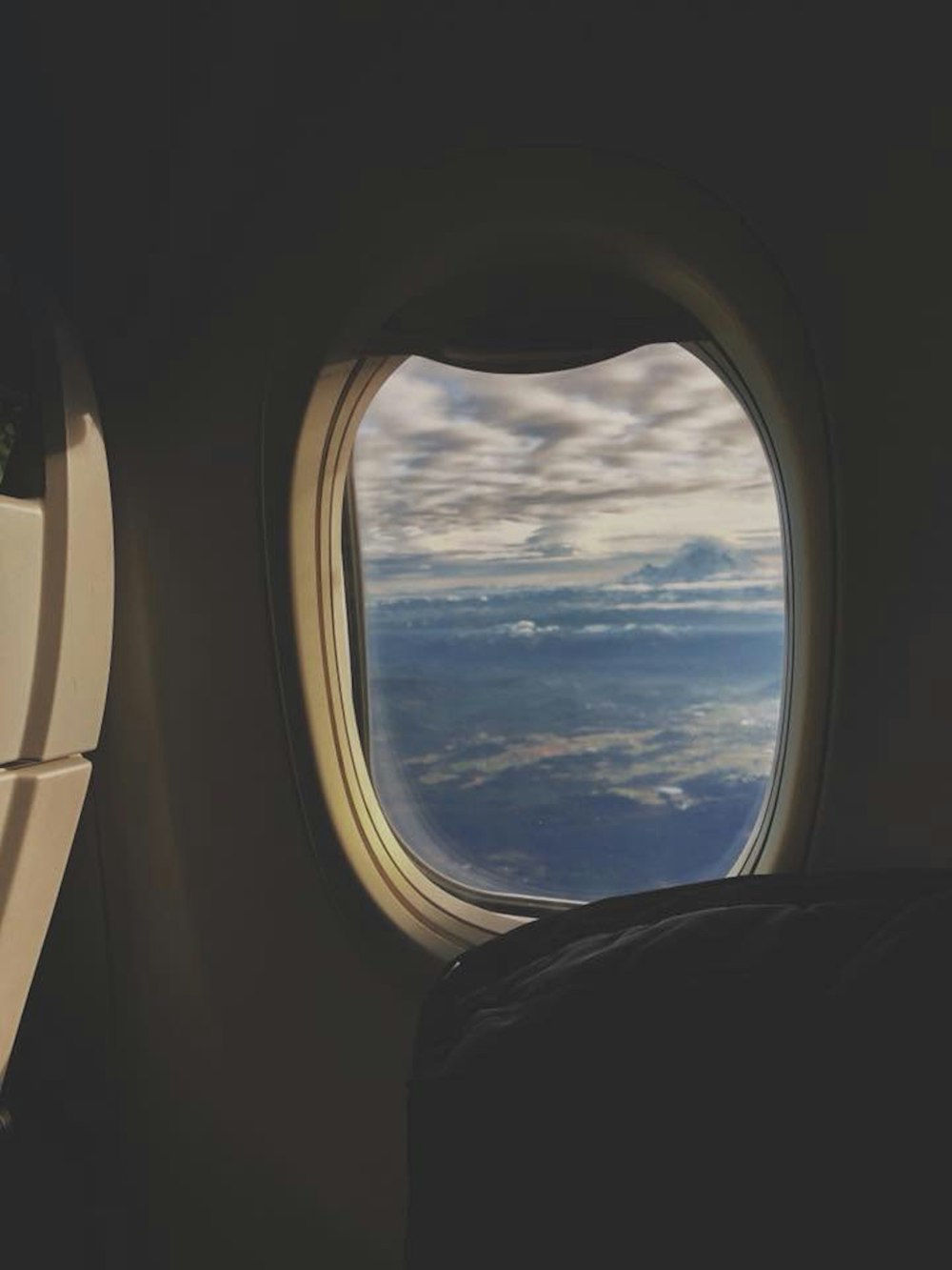 airplane window view of clouds during daytime