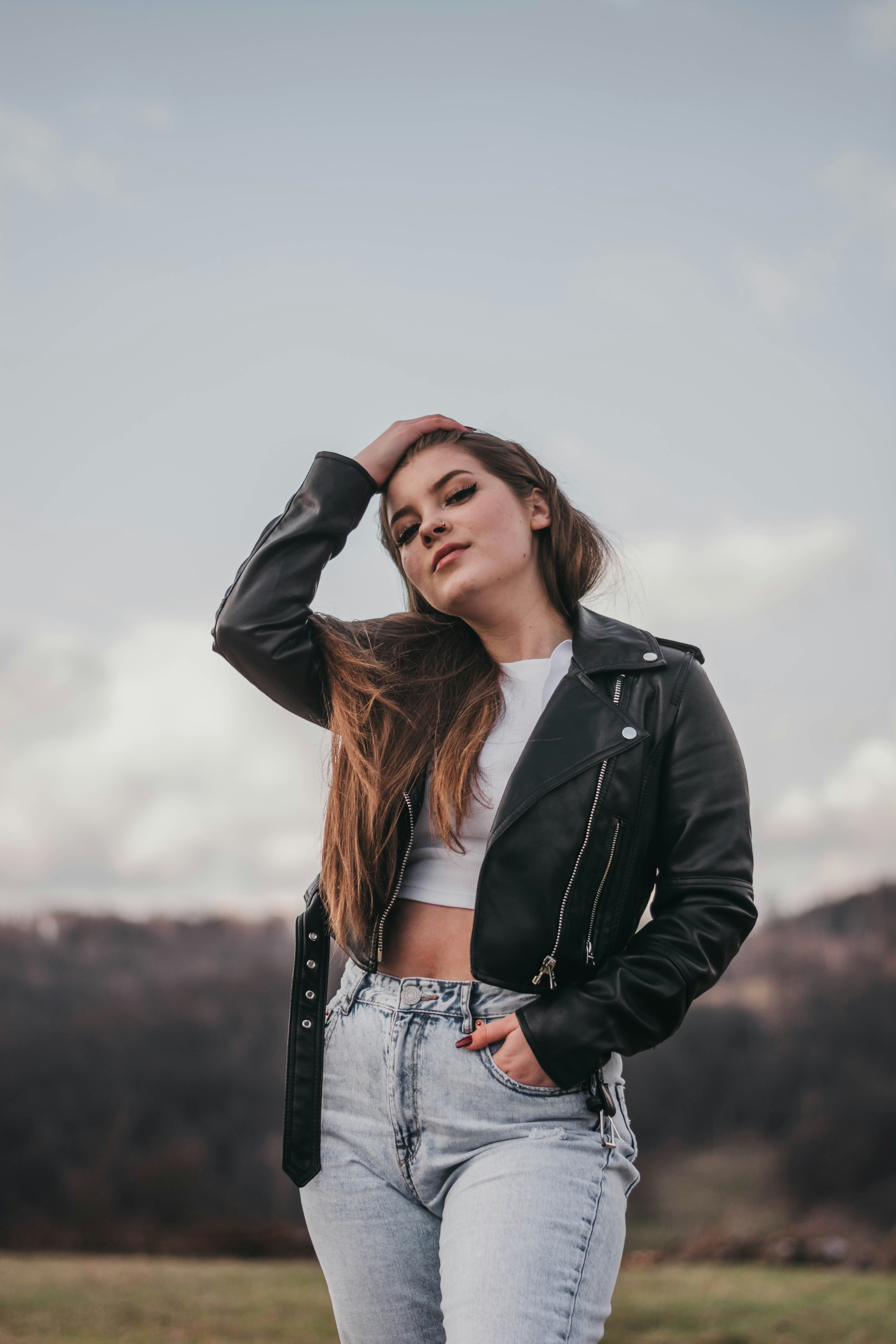 woman in black leather jacket and blue denim jeans