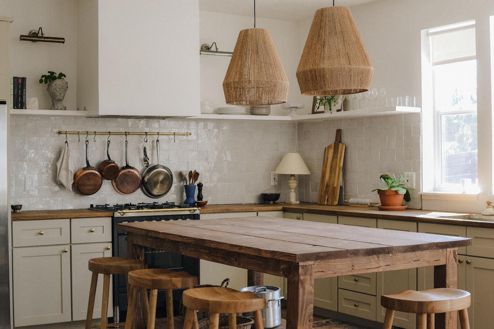 stainless steel cooking pots on white table