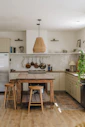 rustic kitchen with wooden island and stools