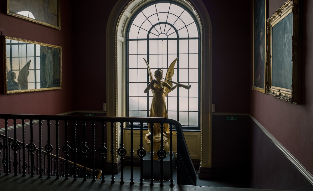 white concrete statue on black metal railings