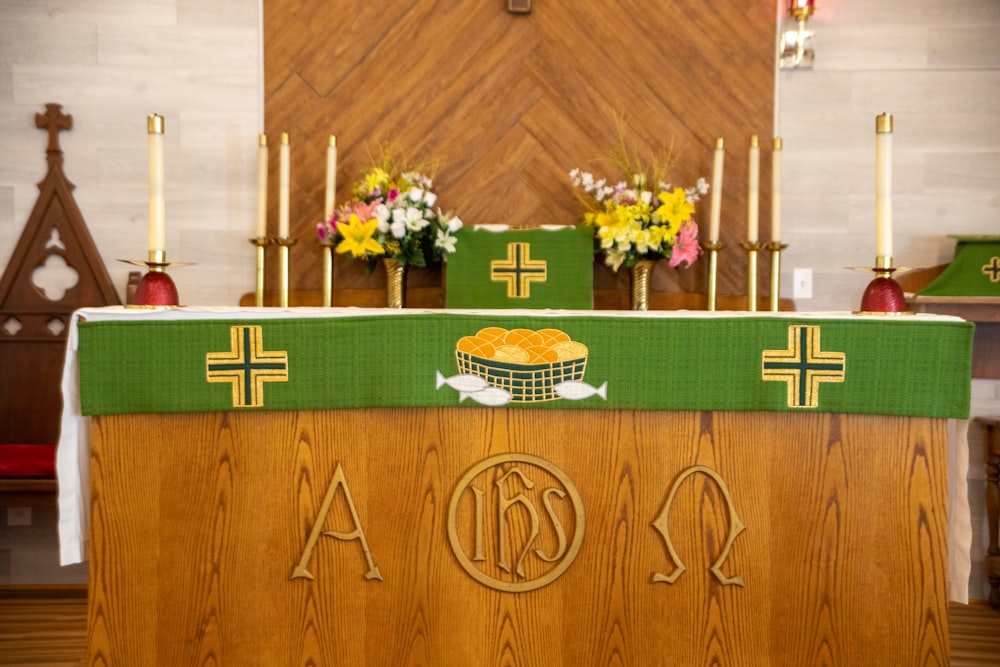 brown and green cross on brown wooden wall