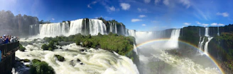 waterfalls under blue sky during daytime