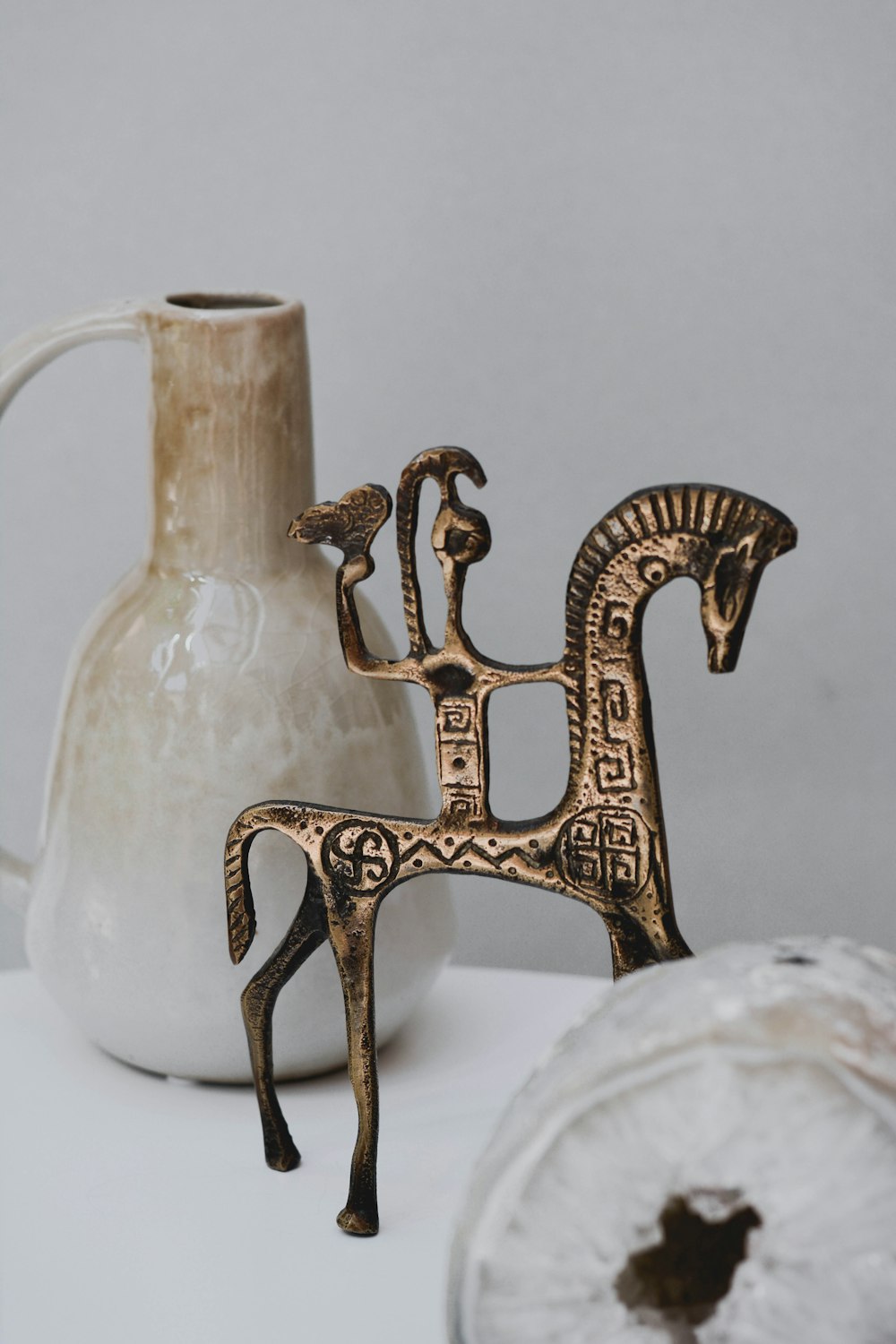 gold metal deer figurine on white textile