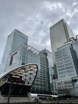 white and black cars on road near gray concrete building during daytime