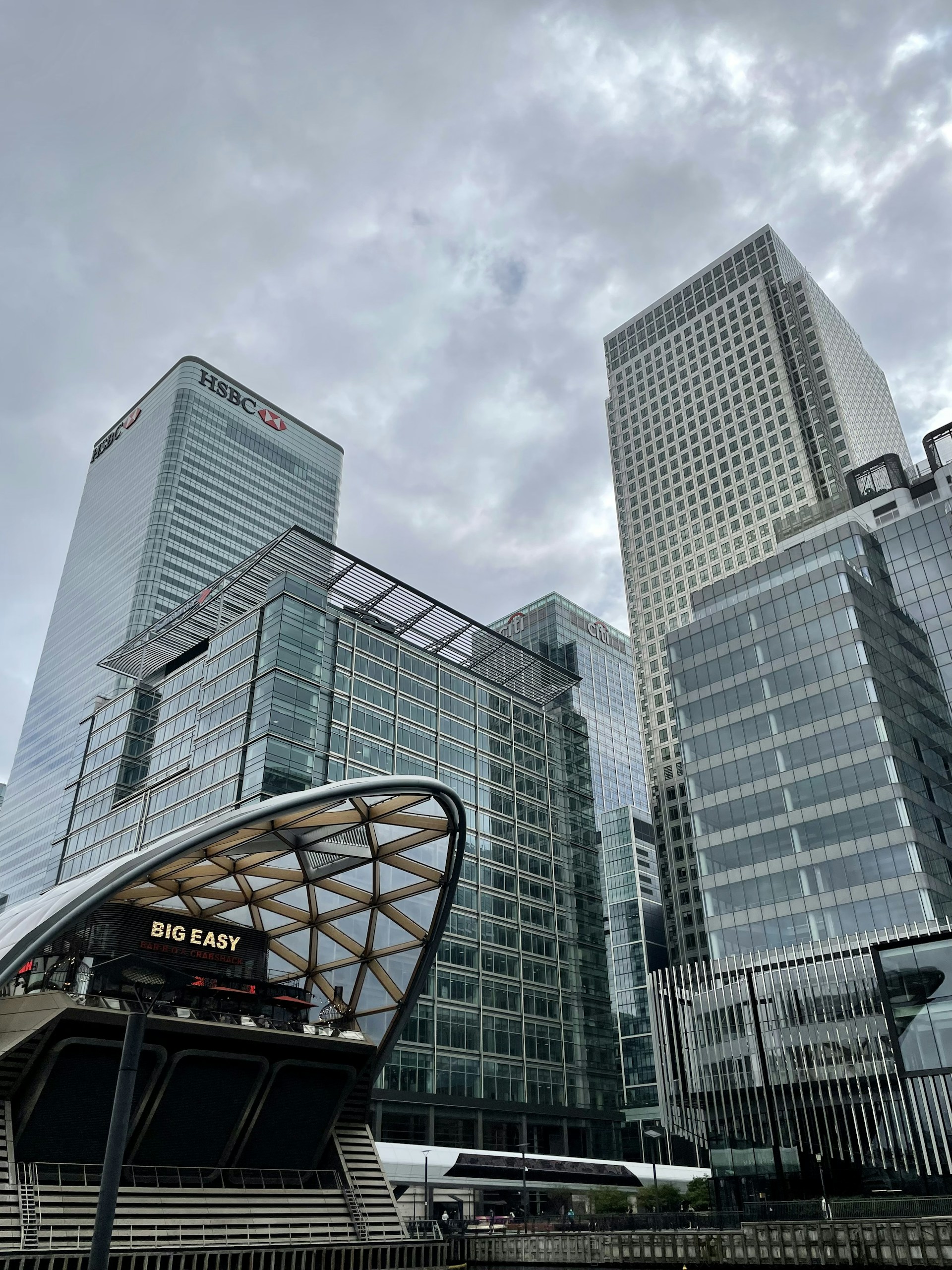 white and black cars on road near gray concrete building during daytime