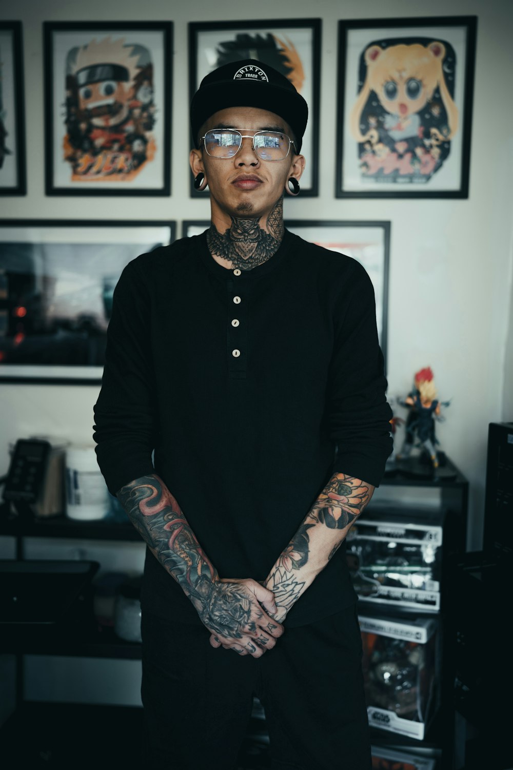 man in black long sleeve shirt with black and red floral tattoo on arm