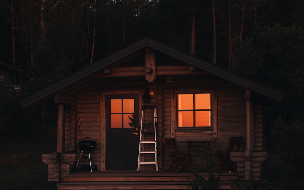 brown wooden house surrounded by trees during night time