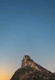 Traveler admiring the iconic Christ the Redeemer statue overlooking the city in a clear day.