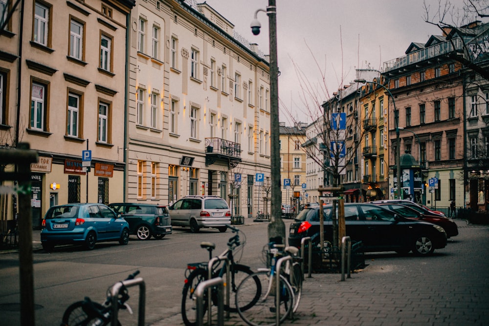 cars parked on side of the road near buildings during daytime