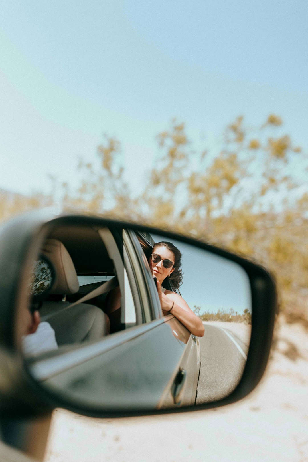 woman in white dress sitting on car seat