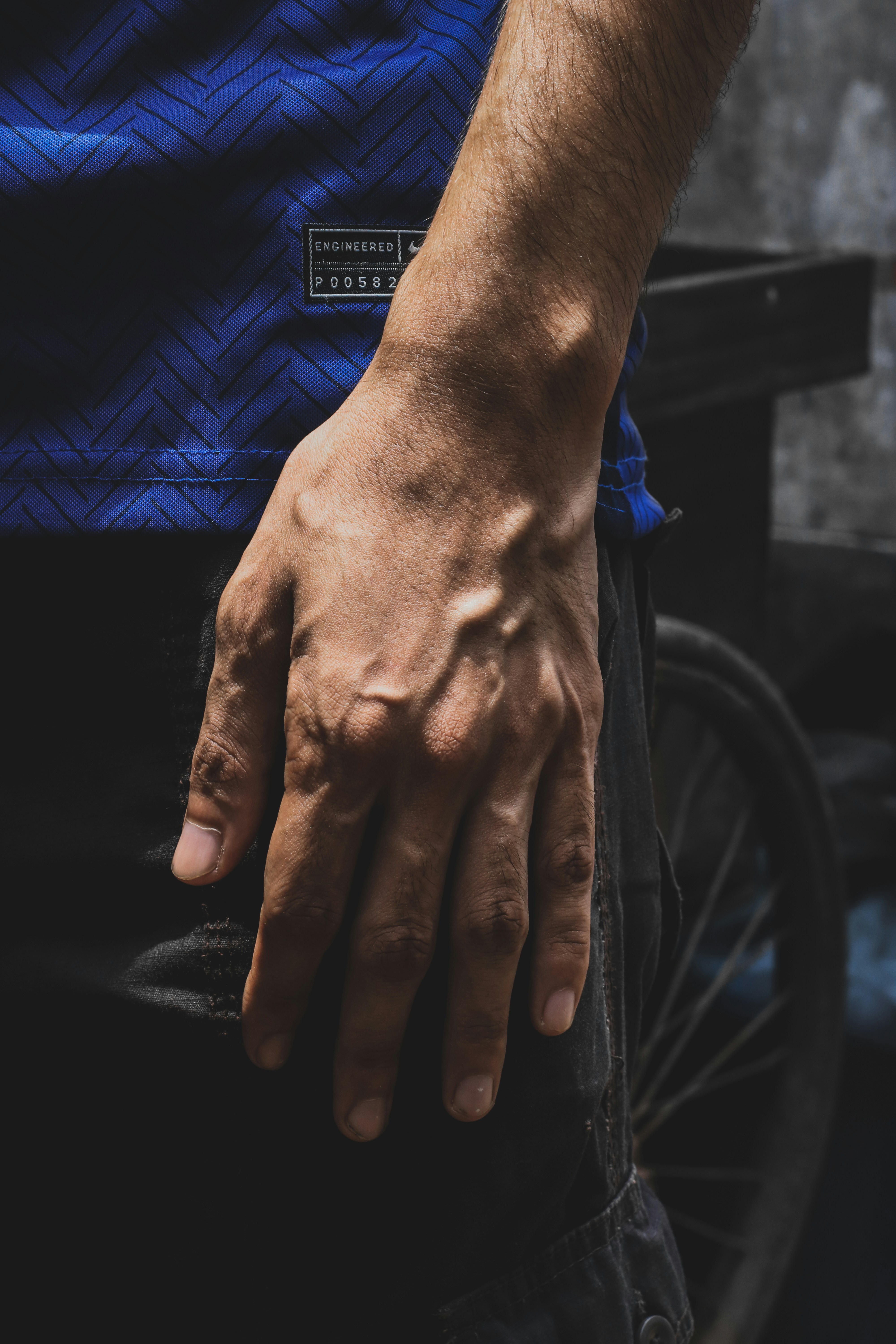 persons hand on black bicycle wheel