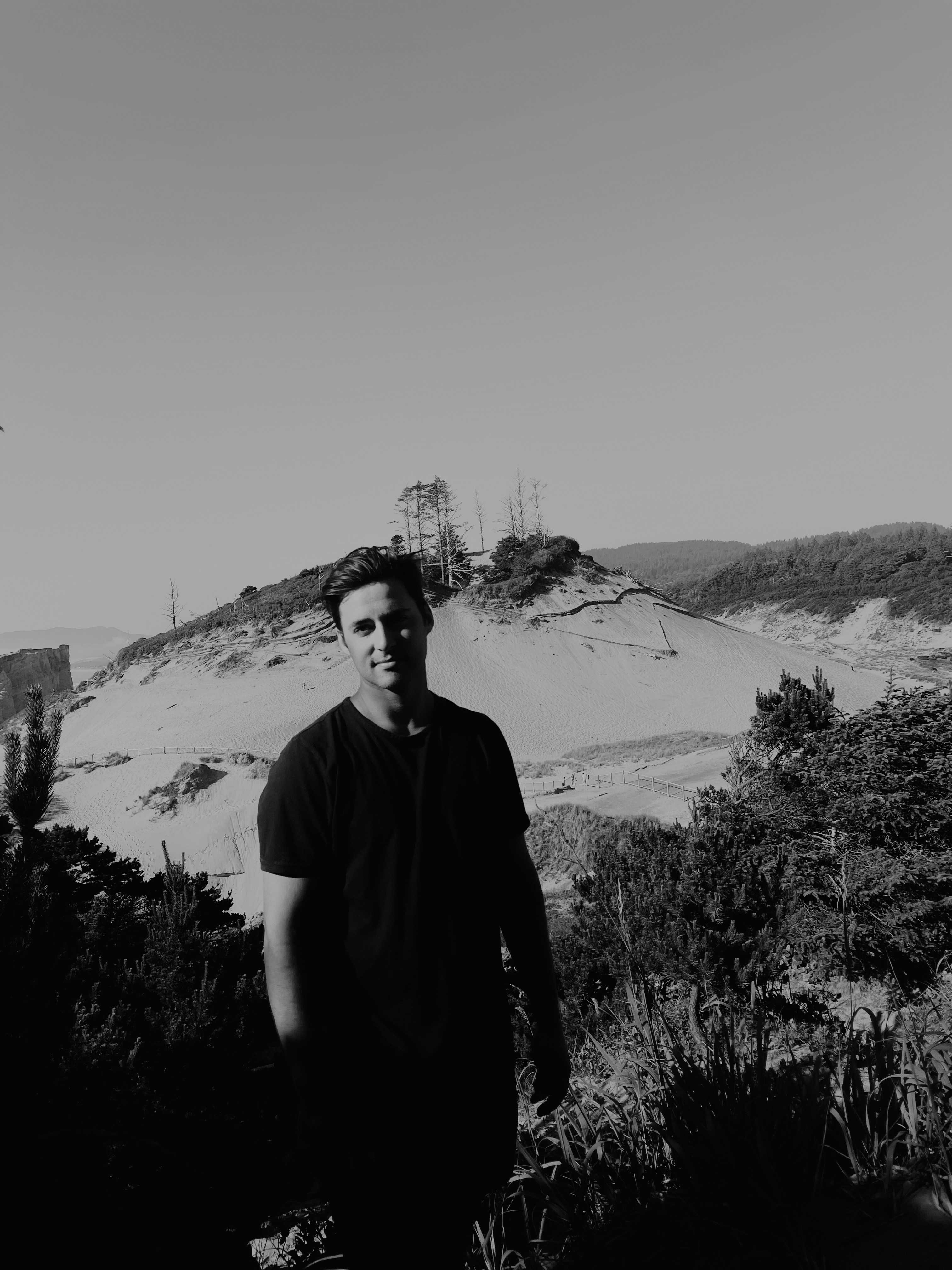 man in black crew neck t-shirt standing on hill