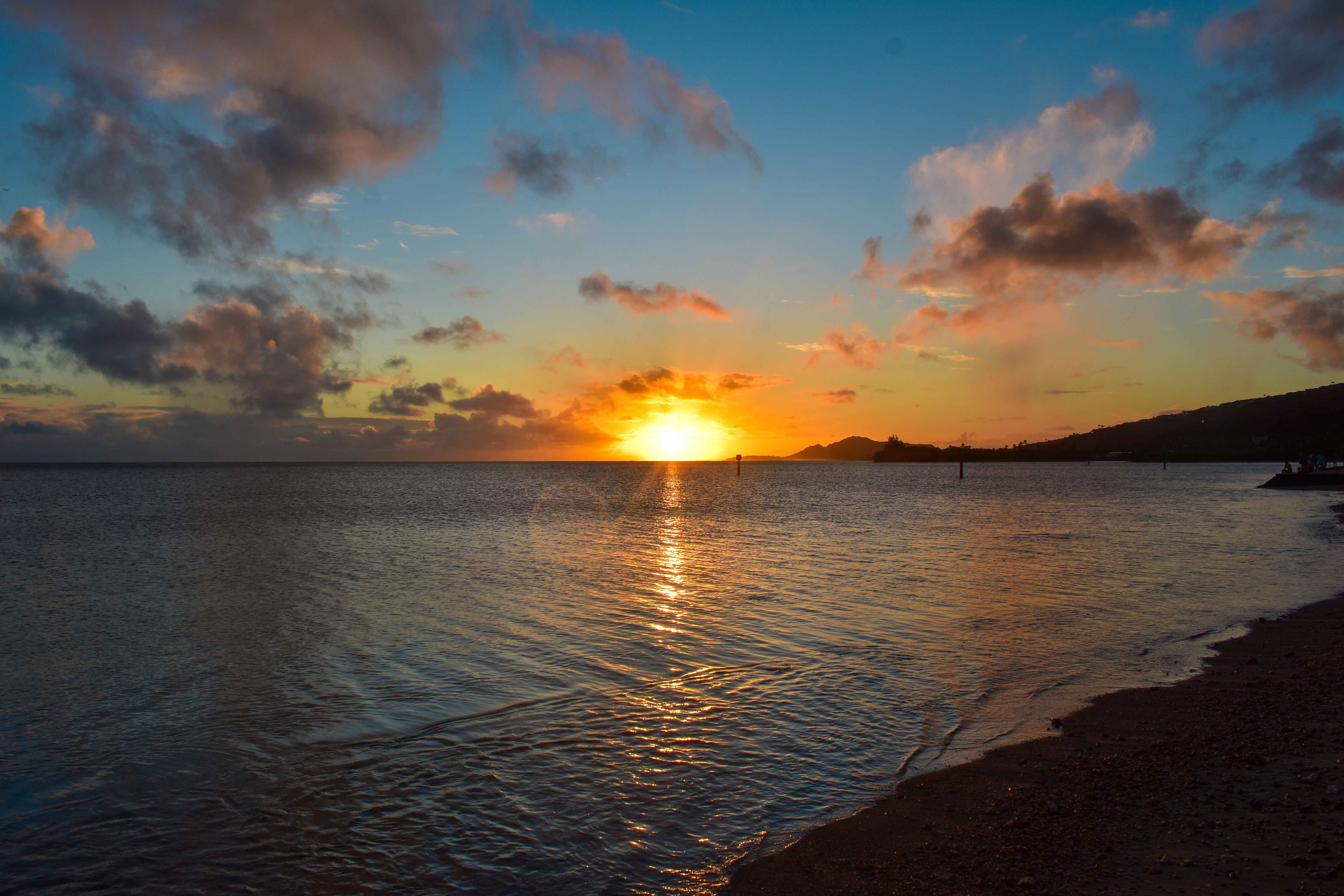 body of water under blue sky during sunset