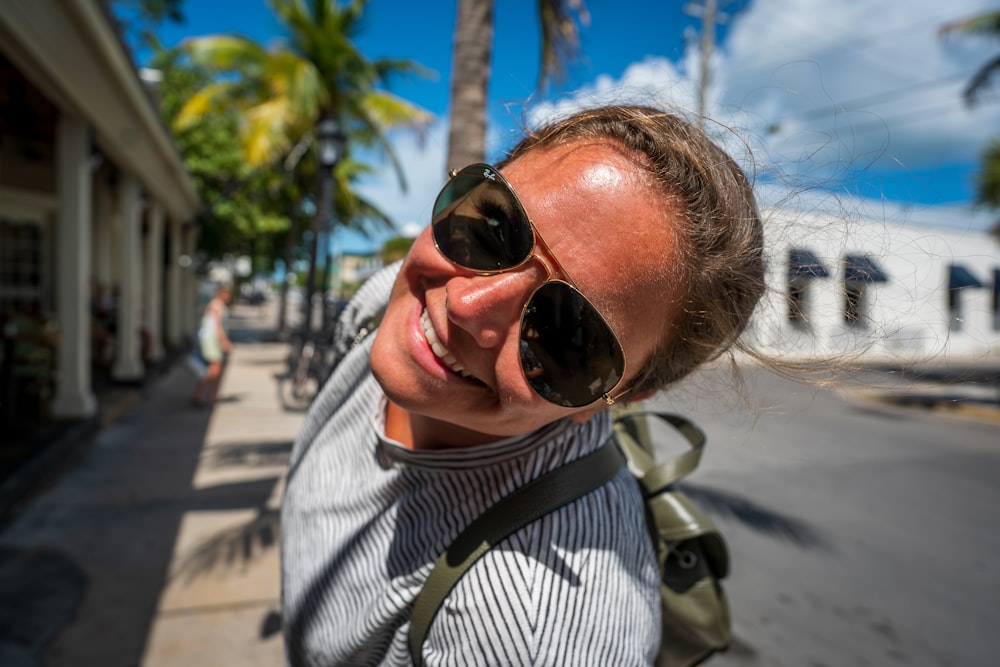 man in black and white striped shirt wearing black sunglasses