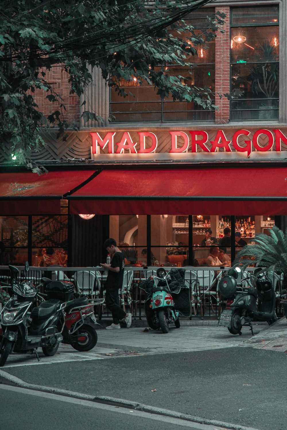 black motorcycle parked beside red and white store