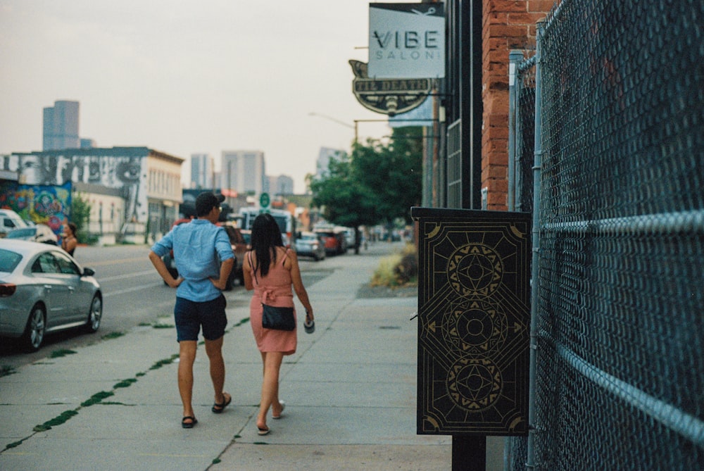 woman in blue denim jacket walking on sidewalk during daytime