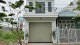 Wide shot showing a new white garage door installed on a modern home.