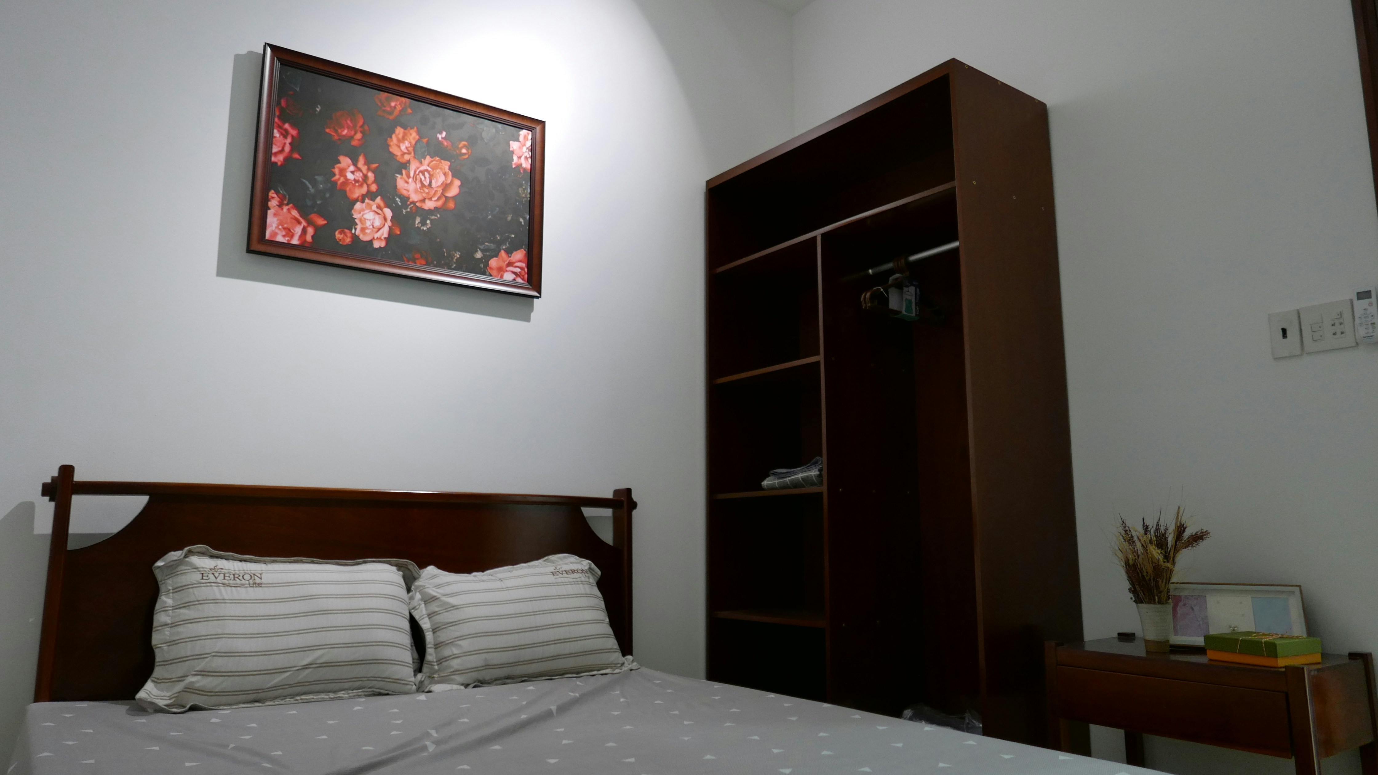 brown wooden cabinet beside bed