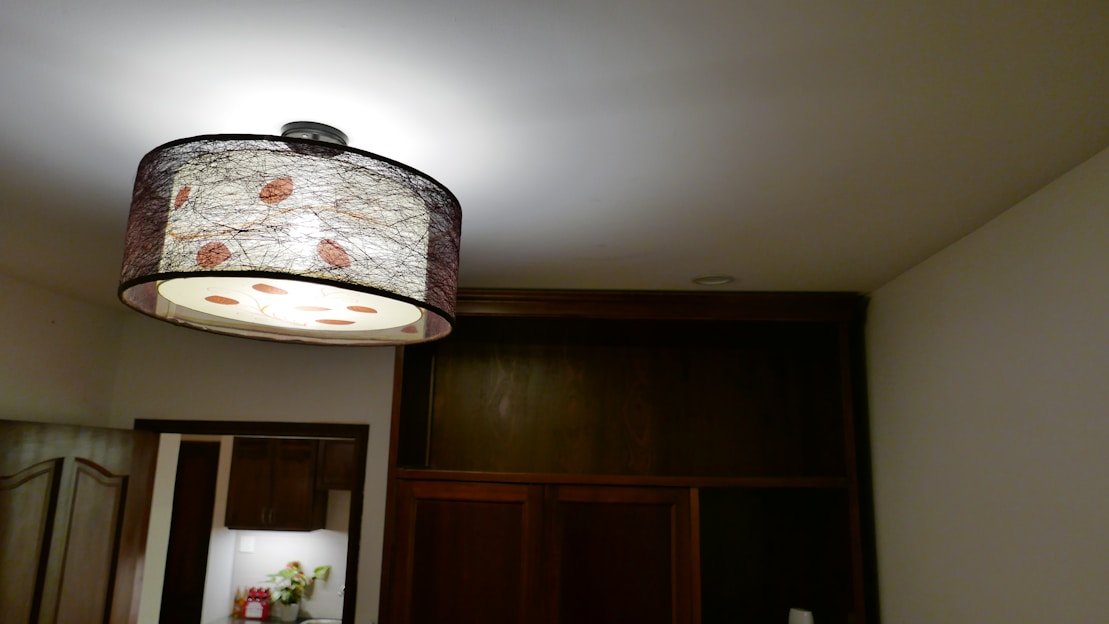 A beautifully designed pendant light hanging in a warm, inviting room.