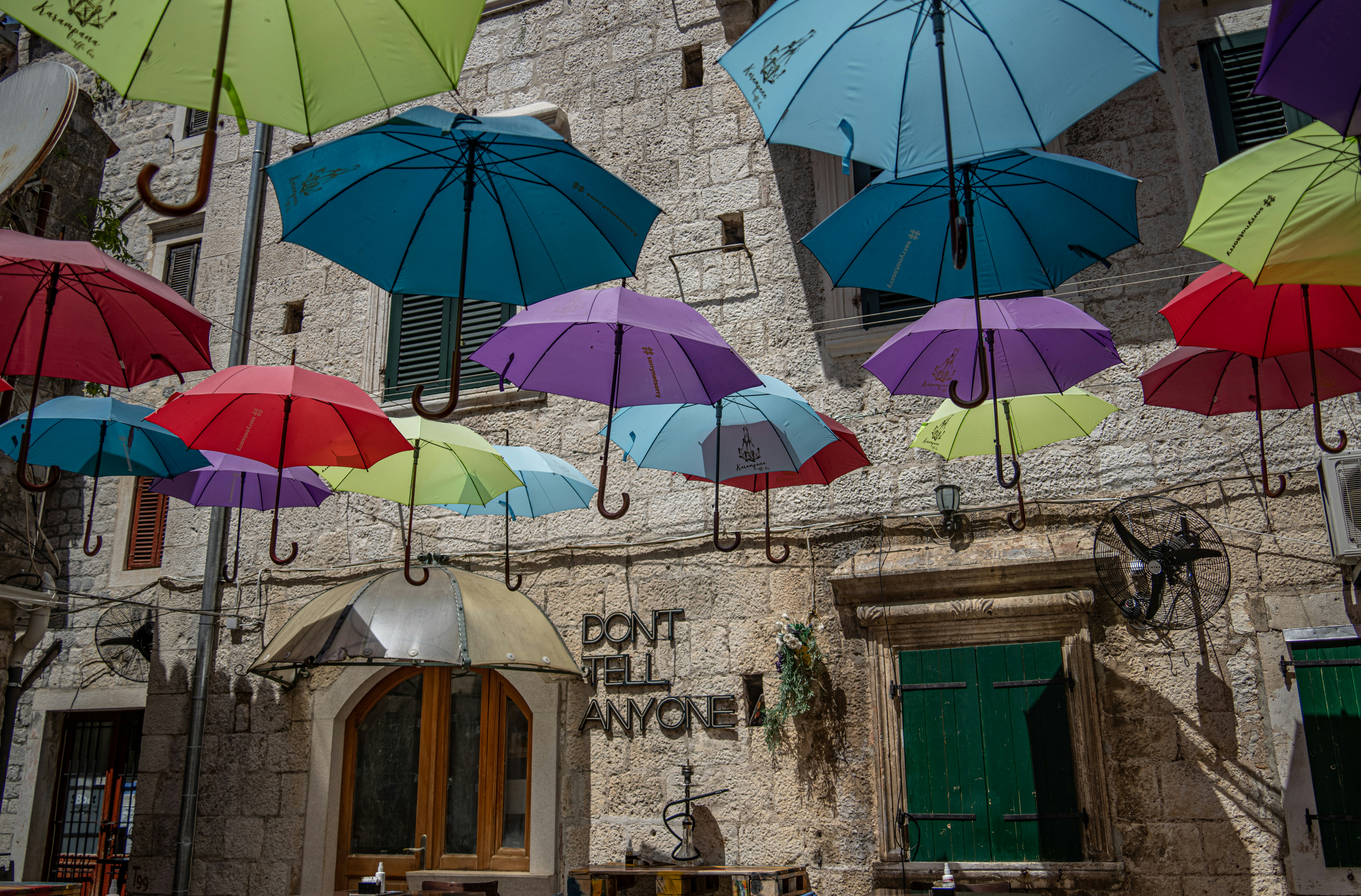 blue umbrella on gray concrete building