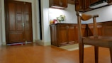 A bright, home-style kitchen with fresh fruits and flowers on the counter.
