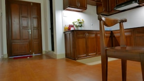A bright, home-style kitchen with fresh fruits and flowers on the counter.