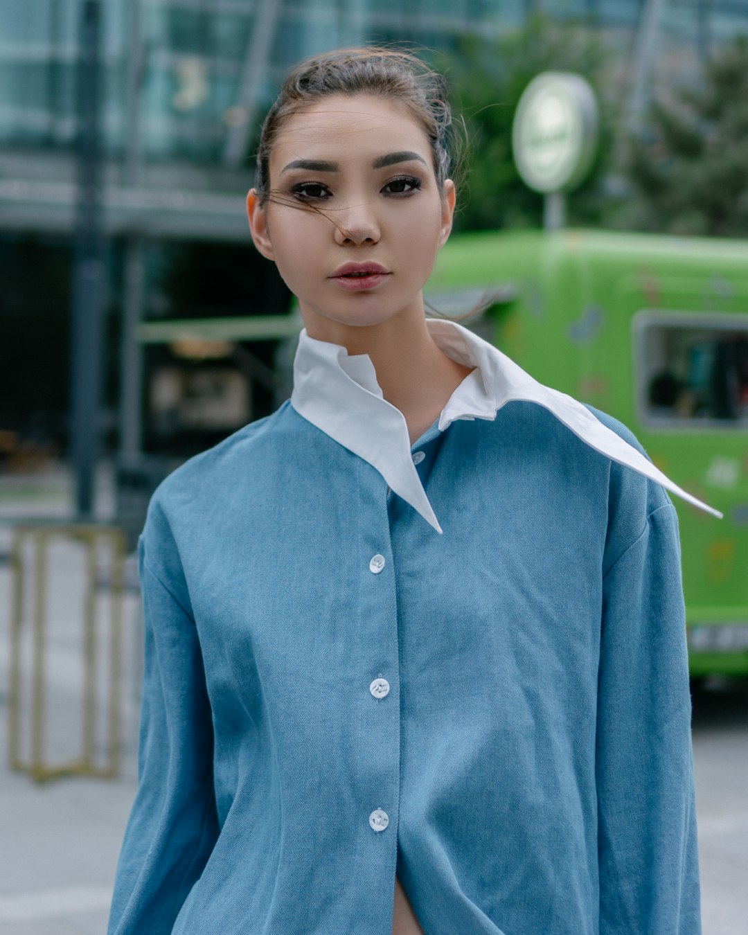 boy in blue button up shirt standing during daytime