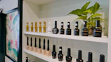 Display of professional Michele Nails and MNP polish bottles arranged elegantly on a black shelf with gold accents.