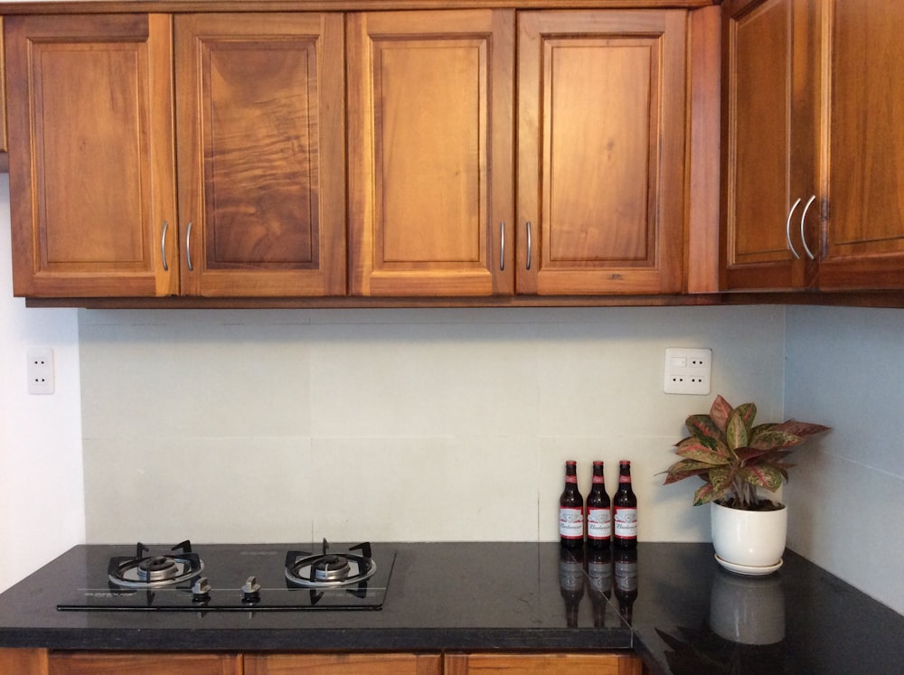 brown wooden kitchen cabinet with white and black gas stove