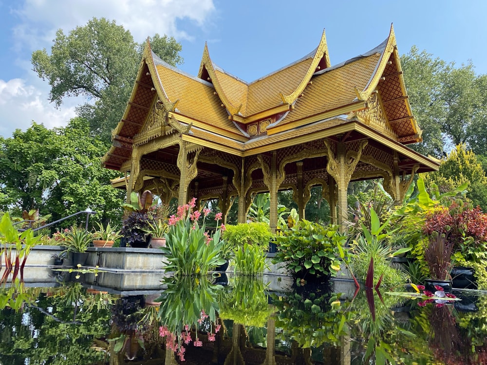 Temple brun et blanc entouré de plantes vertes et d’arbres pendant la journée